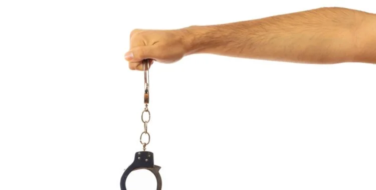 Man dropping handcuffs. Criminal Expungements in West Virginia