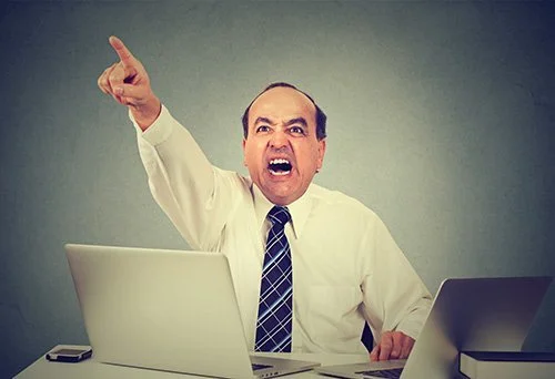 Man angrily firing his employee.
